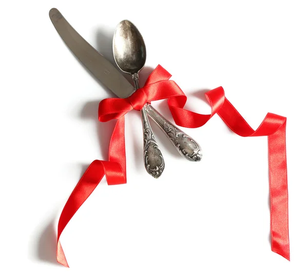 Cutlery tied with ribbon on light background — Stock Photo, Image