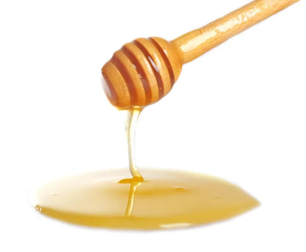 Μέλι στάζει από την κουτάλα για ελαφριά επιφάνεια — Φωτογραφία Αρχείου