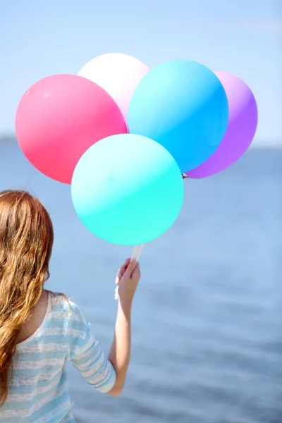 Menina com balões coloridos — Fotografia de Stock