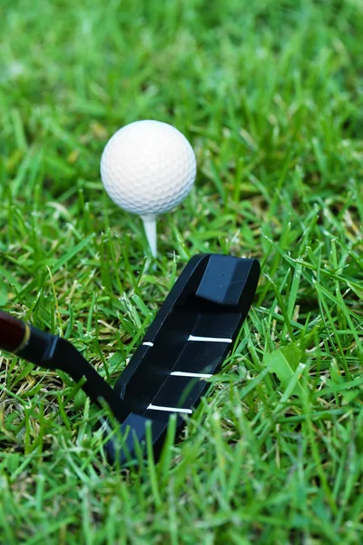 Bolas de golfe e motorista no fundo grama verde — Fotografia de Stock