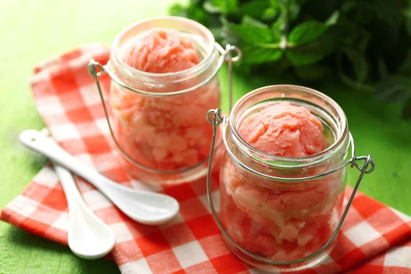 Watermelon ice cream in glass jars  on color wooden background — Stock Photo, Image