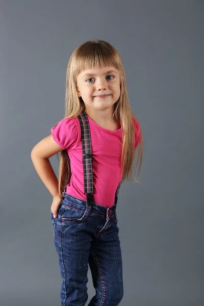 Beautiful little girl on gray background — Stock Photo, Image