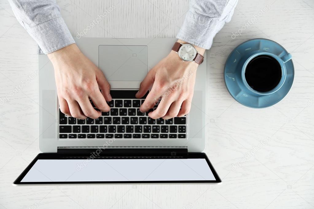 Man working with laptop, top view