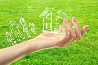 image of happy family on hand, on green grass background