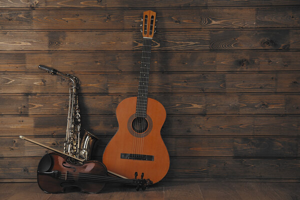 Musical instruments on wooden planks background