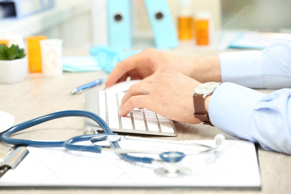 Doctor working at table 