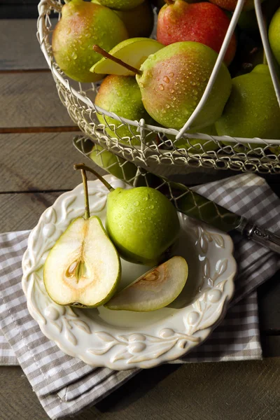 Ripe tasty pears in basket on table close up — Stock Photo, Image