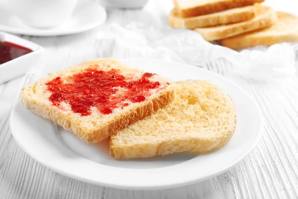 Bread with homemade jam in plate on wooden table, closeup — Stock Photo, Image