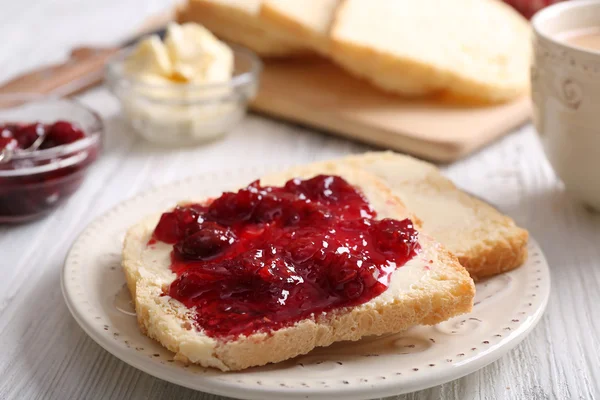 Bread with butter and homemade jam on wooden table, closeup — Stock Photo, Image