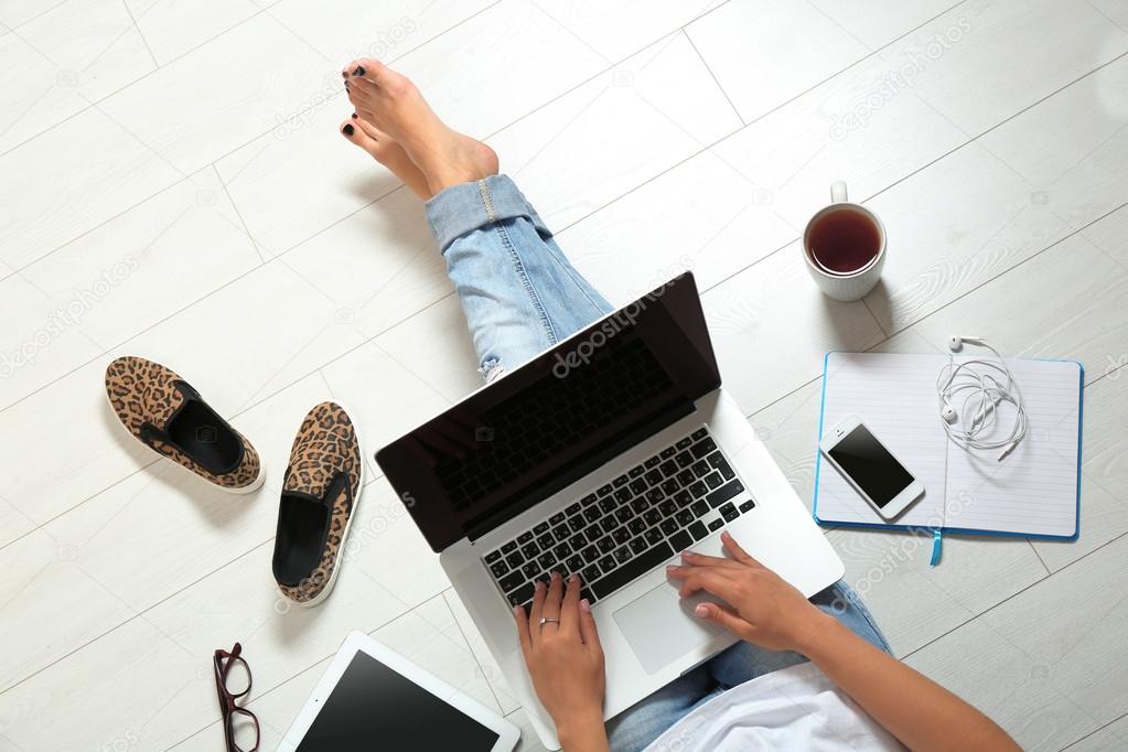 woman sitting on floor with laptop