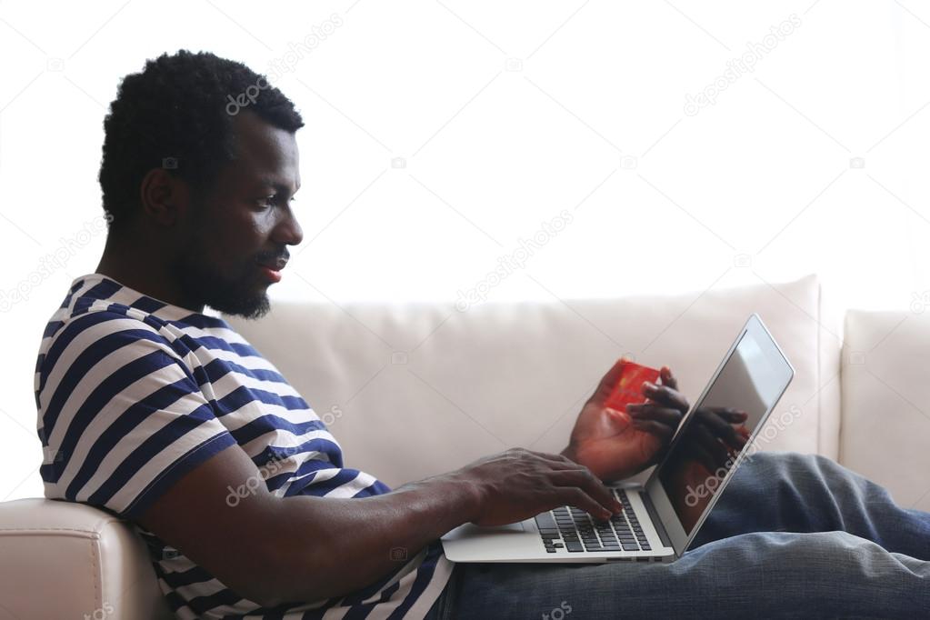 man with laptop and credit card