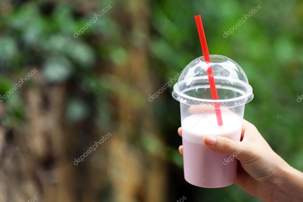 Plastic cup of milkshake with strawberries isolated on white Stock Photo by  ©belchonock 76818941