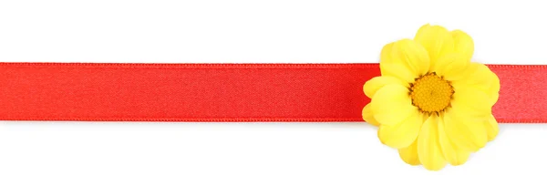 Red ribbon with yellow flower — Stock Photo, Image