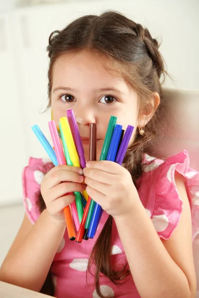 Cute little girl with colorful crayons — Stock Photo, Image