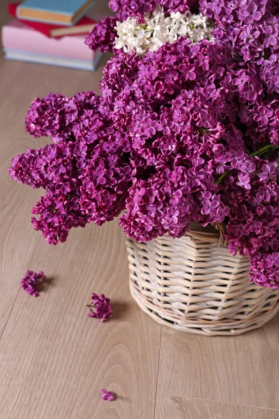 Beautiful lilac flowers in basket — Stock Photo, Image