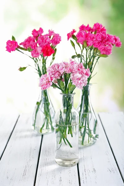 Beautiful bouquet of pink carnation in vases — Stock Photo, Image