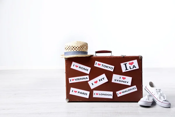 Suitcase with stickers on floor — Stock Photo, Image