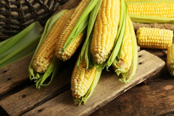 Fresh corn on cobs on wooden table, closeup — Stock Photo, Image