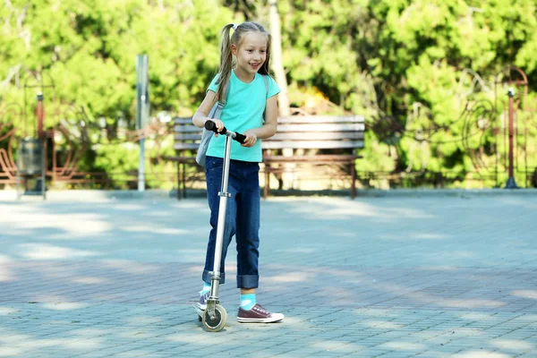 Girl riding on scooter — Stock Photo, Image