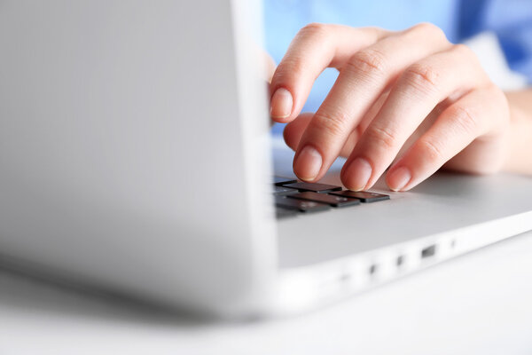 Female hand typing on keyboard