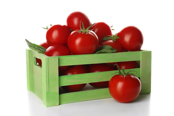 Red tomatoes in green wooden box — Stock Photo, Image