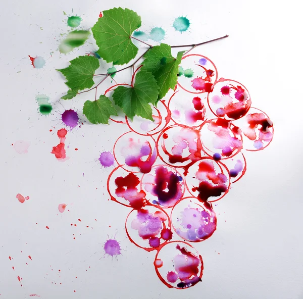 Grapes painted with red wine and cork