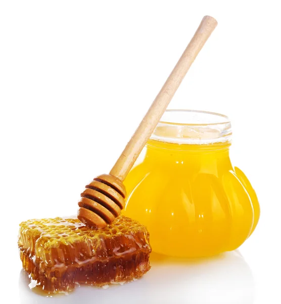 Pot of honey, wooden dipper and honeycomb isolated on white — Stock Photo, Image