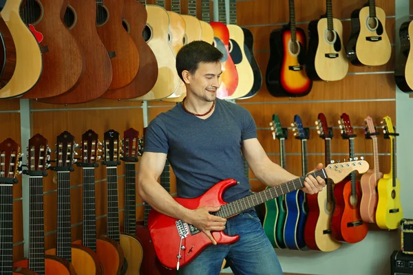 Handsome young man in music store