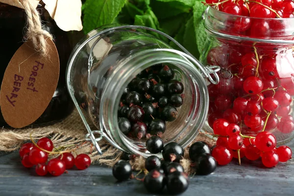 Ripe forest berries in glass jar
