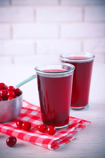 Dvě skleničky s cherry šťáva na stole — Stock fotografie