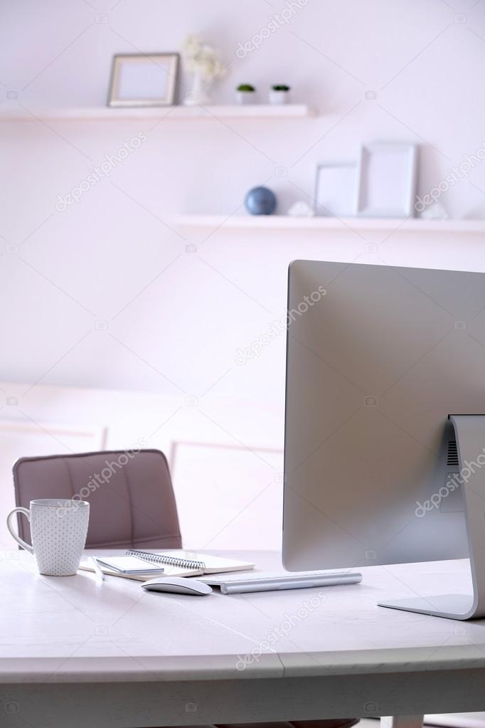Workplace with computer in room