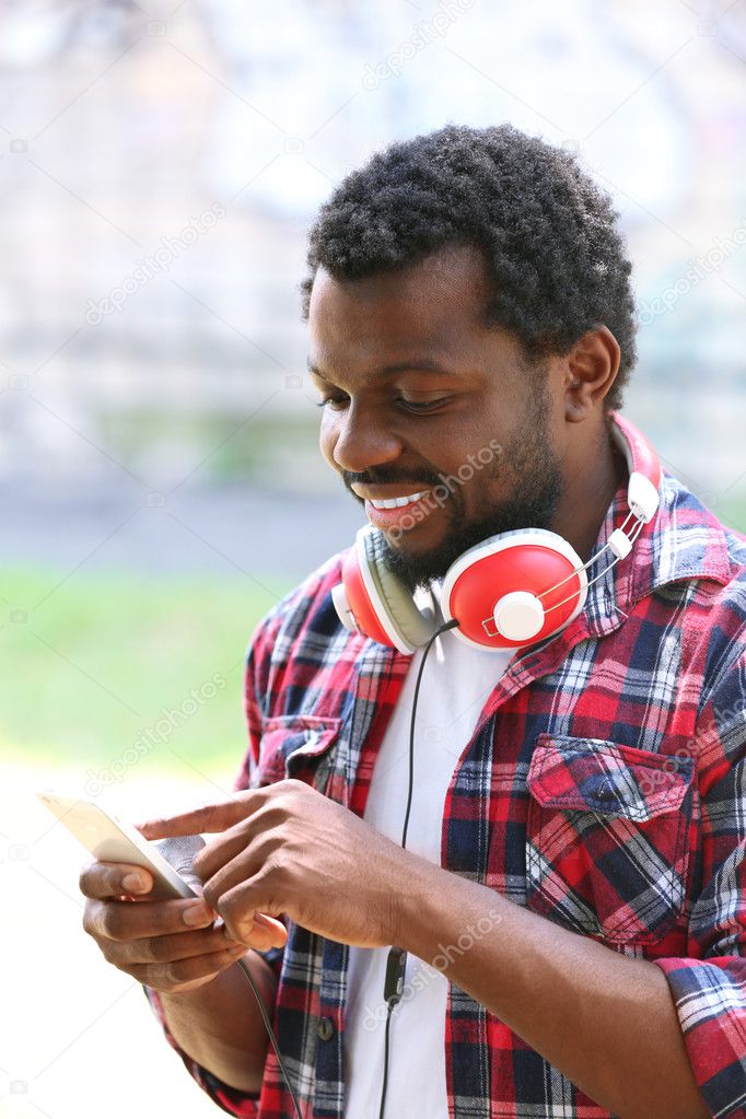 African American man listening music with headphones