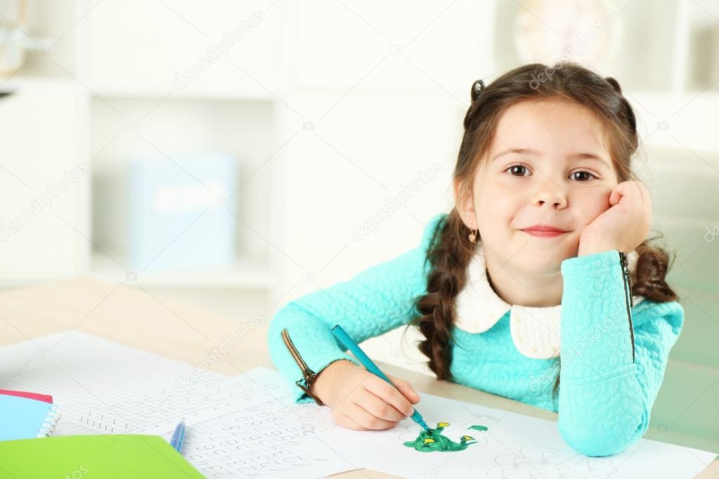 Cute little girl doing her homework