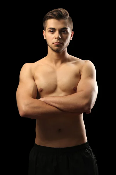 Muscle young man on dark background — Stock Photo, Image