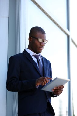 İş Merkezi yakınındaki dijital tablet ile yakışıklı Afrikalı-Amerikalı işadamı