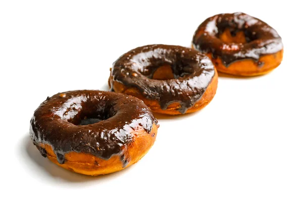 Delicious doughnuts with chocolate icing isolated on white — Stock Photo, Image