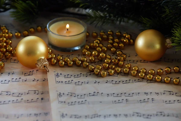 Christmas decorations on music sheets, closeup — Stock Photo, Image