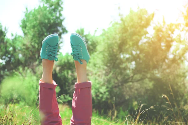 Female legs in colorful sneakers outdoors — Stock Photo, Image