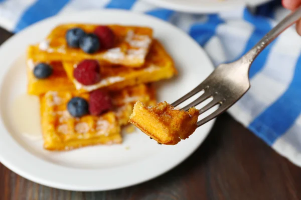 Sweet homemade waffles with forest berries and sauce on table background — Stock Photo, Image
