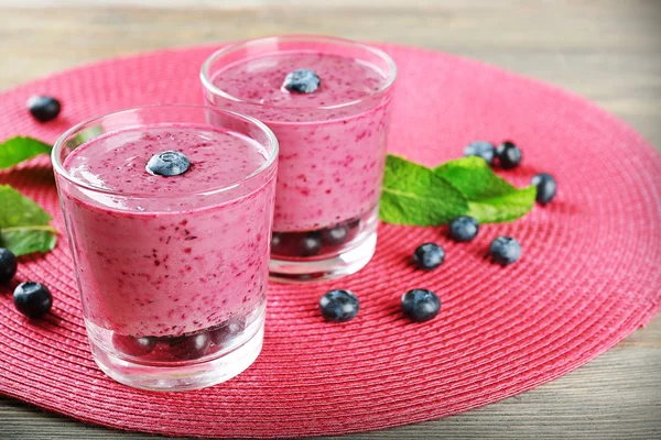 Gläser Blaubeer-Smoothie auf rosa Matte, Nahaufnahme — Stockfoto