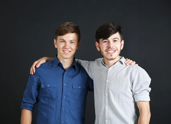 Two brothers on dark background — Stock Photo, Image