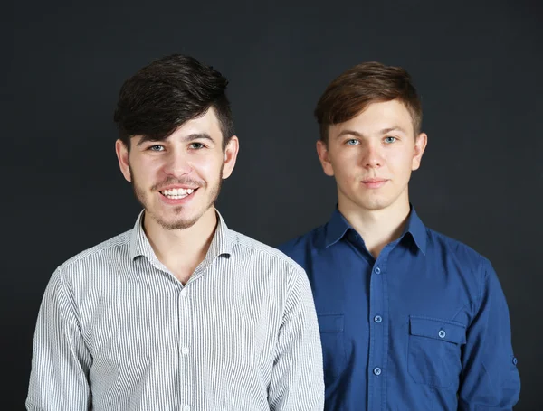 Two brothers on dark background — Stock Photo, Image