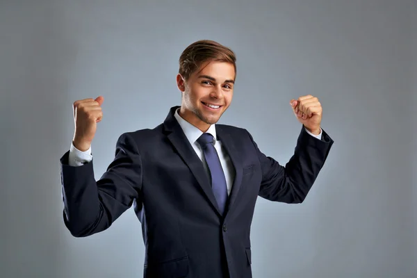 Elegant man in suit on gray background — Stock Photo, Image