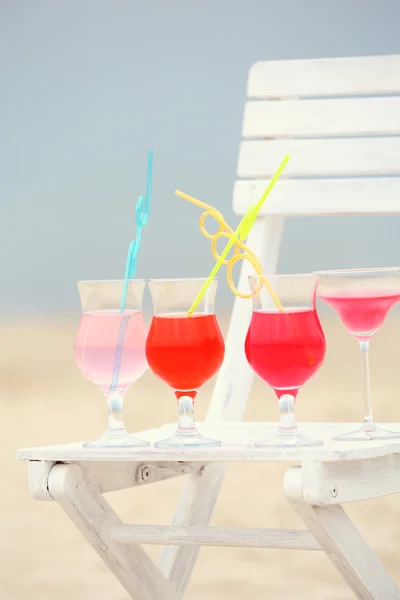 Refreshing cocktail on chair outdoors — Stock Photo, Image