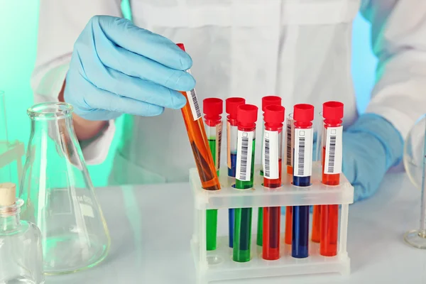 Test tubes with liquid in scientist hand — Stock Photo, Image