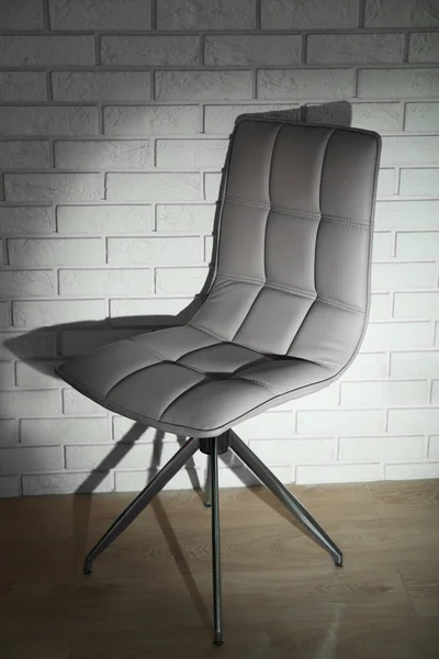 Modern chair on wall background — Stock Photo, Image