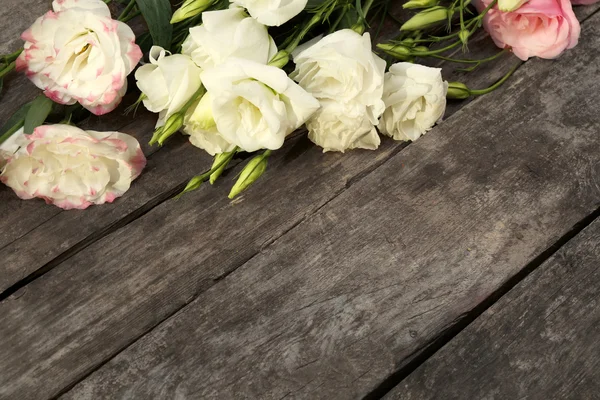 Beautiful eustoma on wooden background — Stock Photo, Image