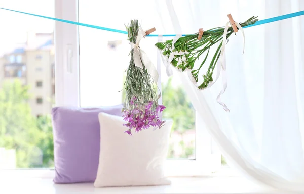 Various herbs and flowers drying on thong — Stock Photo, Image