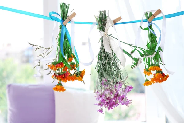 Various herbs and flowers drying on thong — Stock Photo, Image