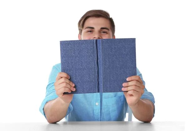 Genç adam okuma kitabı masada beyaz arka plan üzerinde — Stok fotoğraf